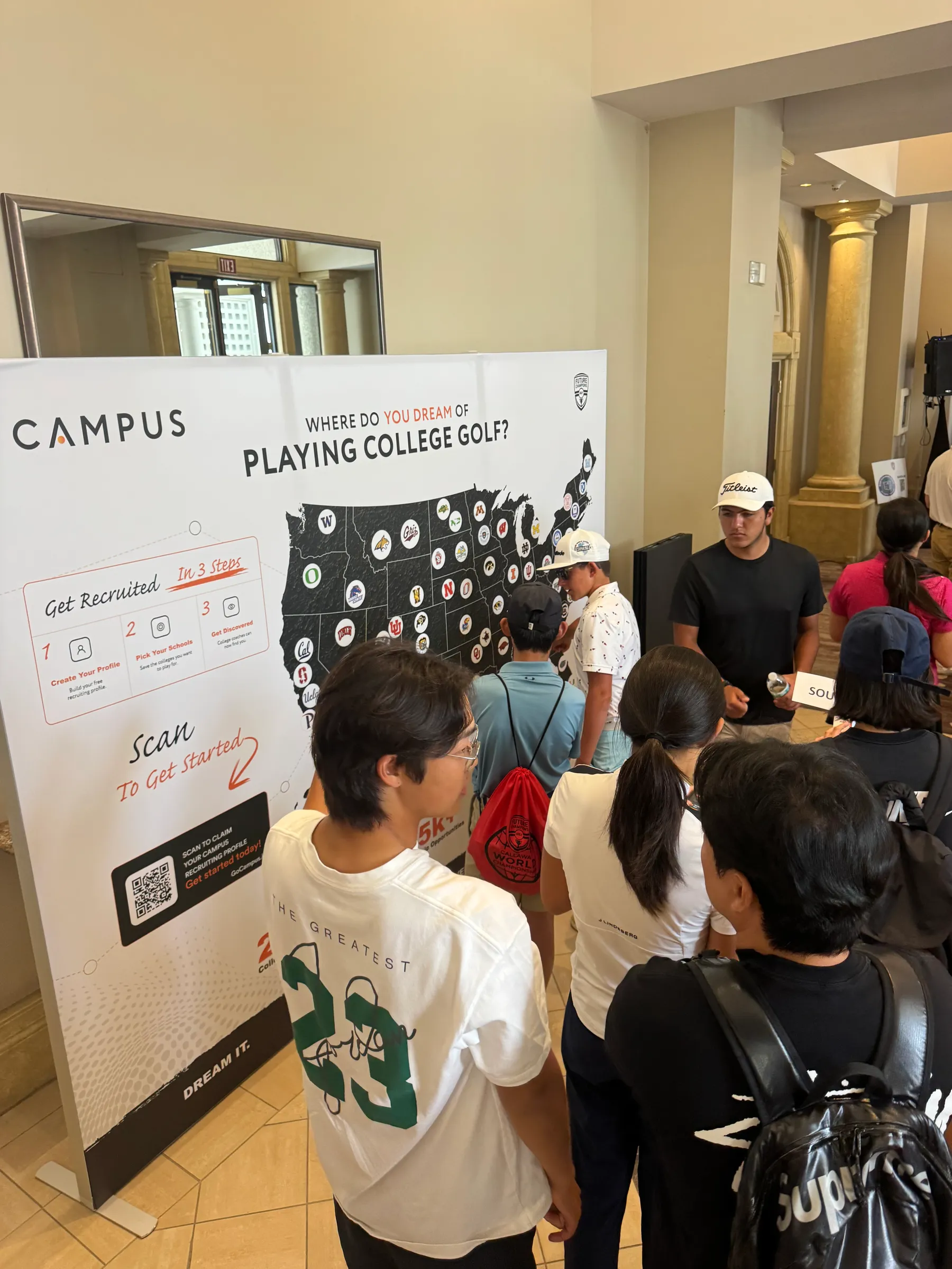 Attendees engaging with the Campus backdrop