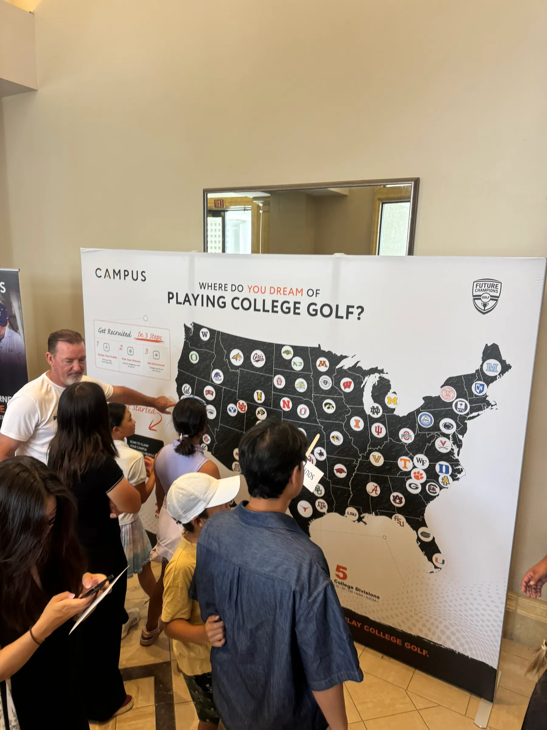 A crowd gathered around the Campus backdrop on the event floor